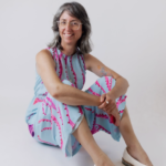 Alison Lasek astrologer and kundalini yoga teacher sitting on a white background 